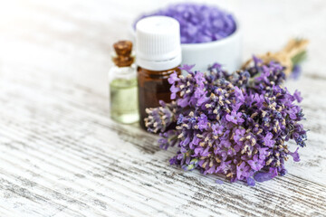 Fototapeta na wymiar lavender's spa products with dried lavender flowers on a wooden table. Flat lay bath salt and massage oil on wooden background. Skin care, beauty treatment concept. Lavendula oleum