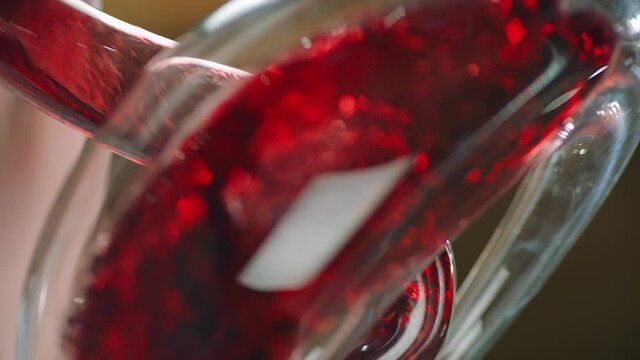 Sommelier pouring red wine from bottle into decanter . Close-up footage of wine mixing process in carafe . Preparation process to degustation of wine. Shot on RED HELIUM Cinema Camera in Slow Motion.