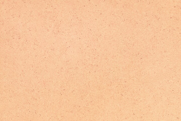 A sheet of hardboard covered with small dots, scratches and inclusions. Cardboard mottled heterogeneous texture.