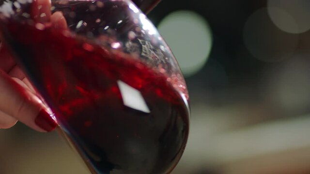 Sommelier pouring red wine from bottle into decanter . Close-up footage of wine mixing process in carafe . Preparation process to degustation of wine. Shot on RED HELIUM Cinema Camera in Slow Motion.