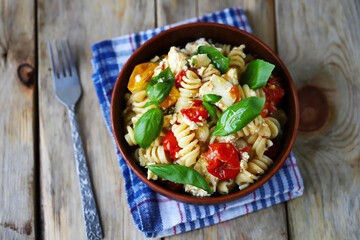 Feta tomato pasta in a bowl. Italian style cuisine.