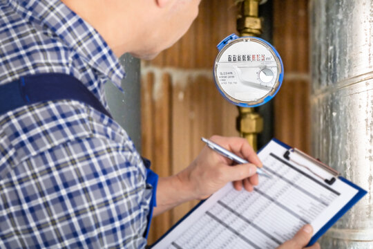 Technician With Clipboard Reading Water Meter