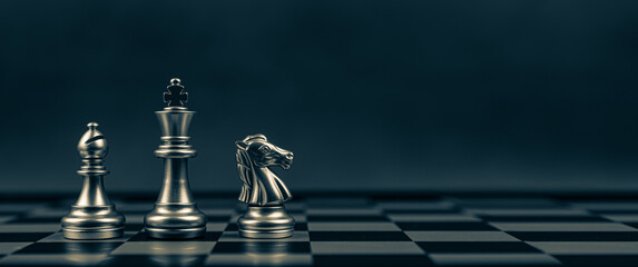 Close-up King chess Bishop and Knight standing teamwork on chess board concepts of business team and leadership strategy and organization risk management or team player. - obrazy, fototapety, plakaty