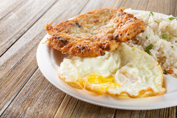 A view of a plate of tortang dulong, also known as deep fried silverfish, with fried eggs.