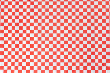 A view of an entree paper liner featuring a red and white checker pattern.