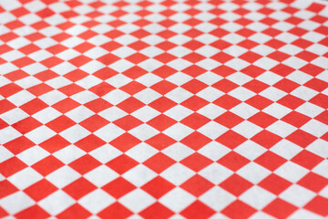 A view of an entree paper liner featuring a red and white checker pattern.