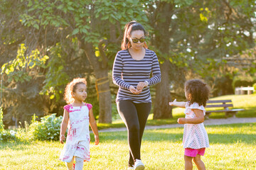 Fototapeta premium Happy young mother hispanic with her daughter at park