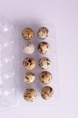 quail eggs in packaging on a white table