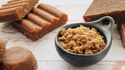 panela, from sugar cane, for different preparations on a white wooden base, made in Colombia.