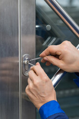 Male Lockpicker Fixing Door Handle At Home