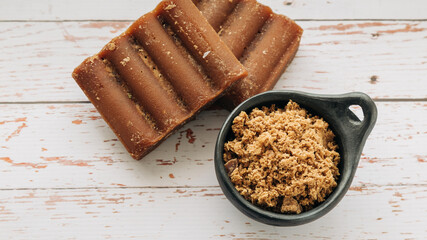 panela, from sugar cane, for different preparations on a white wooden base, made in Colombia.