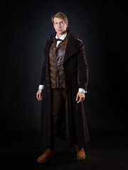 character of the steampunk story, a young attractive man in an elegant long coat - 452151781