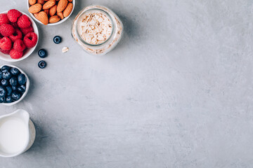 Healthy breakfast. Ingredients for oatmeal. Blueberries, strawberries, almonds, milk and oats.