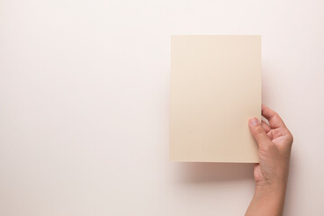 White booklet mockup. Female hands hold an empty blank. Blank form, mockup
