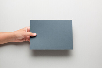 White booklet mockup. Female hands hold an empty blank. Blank form, mockup
