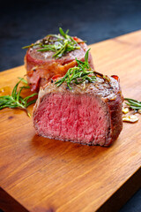 Modern style traditional fried dry aged angus beef filet medaillons natural wrapped with bacon and...
