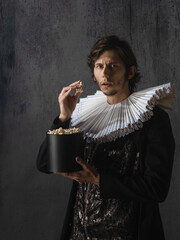 A young man is watching a movie, a Renaissance spectator,