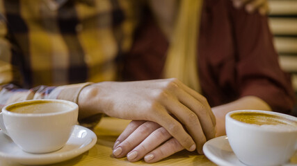 Young man holding girlfriend's hand, tender feelings, romantic date, close-up