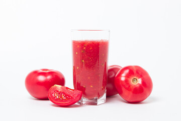 A glass of tomato juice on a white background. Natural freshly squeezed tomato juice.
