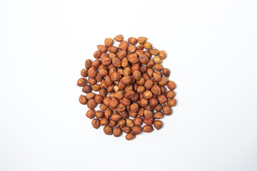 Peeled hazelnuts on a white background. Healthy diet