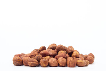 Peeled hazelnuts on a white background. Healthy diet