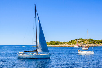 Obraz premium Sailing yacht with white sail sailing in the sea, Croatia