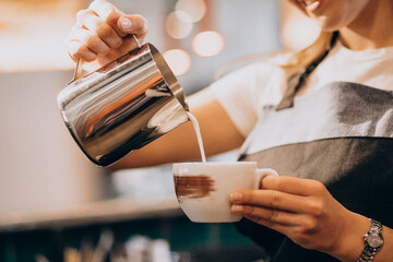 Fototapeta na wymiar female barista working in a coffee shop