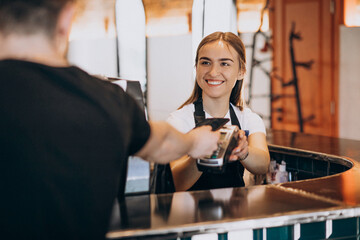 Customer paying with card in a coffee house