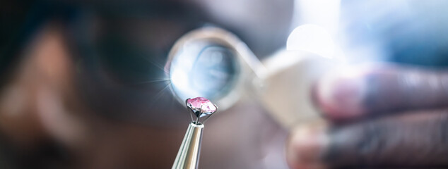 African American Jeweler Holding Diamond And