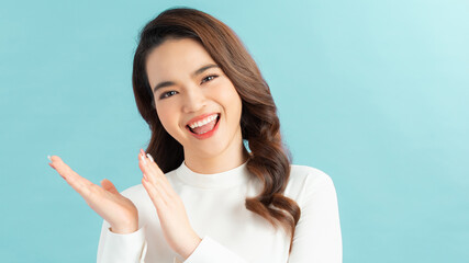 young pretty woman feeling happy and successful, smiling and clapping hands, saying congratulations...