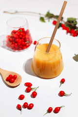 Fresh goji berries in a transparent glass and fresh berry juice.