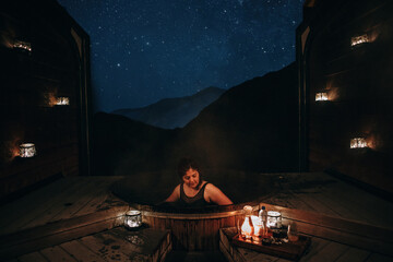 Woman relaxing in an Onsen Hot Pools in Queenstown at night. New Zealand