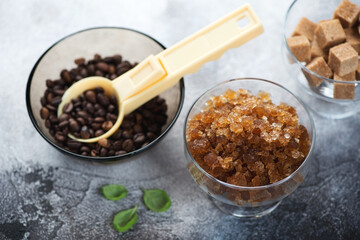 Bowl of coffee granita, coffee beans and brown sugar over dark grey stone background, horizontal shot