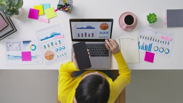 Above top desk of SME owner people home office call talk in SEO chart sale report paper or stock graph big data. Woman remote study MBA digital learn online of job career reskill upskill work plan.