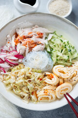 Closeup of korean traditional cold kuksi soup with chicken and chicken bouillon, selective focus, vertical shot