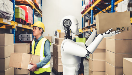 Innovative industry robot working in warehouse together with human worker . Concept of artificial...