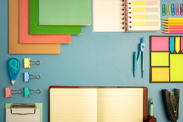 Stationery concept. Fat lay top view of notebook, clip board, color notepad, memo, dividers,...