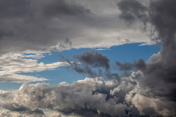 Dramatic sky with grey clouds over the city before the storm. Weather before or after a storm.
