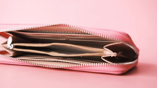 empty wallet on pink background 