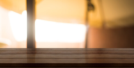 Empty wooden table top with lights bokeh on blur restaurant background.