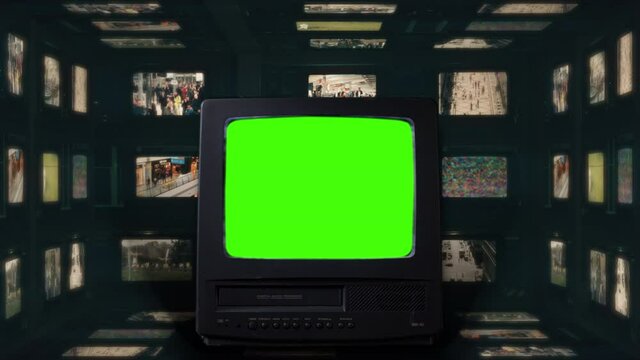 Vintage Green Screen TV Inside Box of Televisions. Old tv green screen in front of many televisions with vintage movies in the background