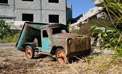 A forgotten toy near an abandoned house