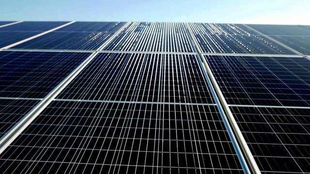 Solar power panel, sunlight reflection photovoltaic PV module solar energy plant farm close up background.