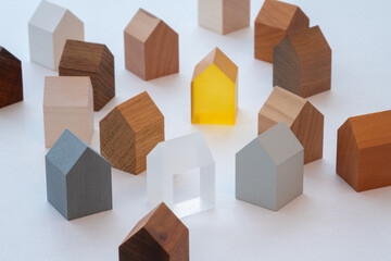 Group of similar tiny wooden model houses.