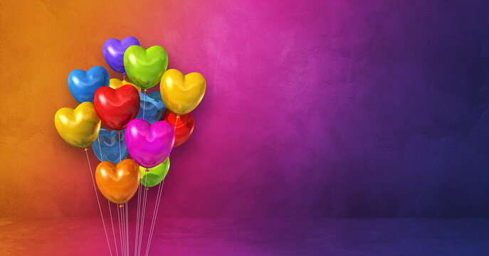 Colorful heart shape balloons bunch on a rainbow wall background. Horizontal banner.