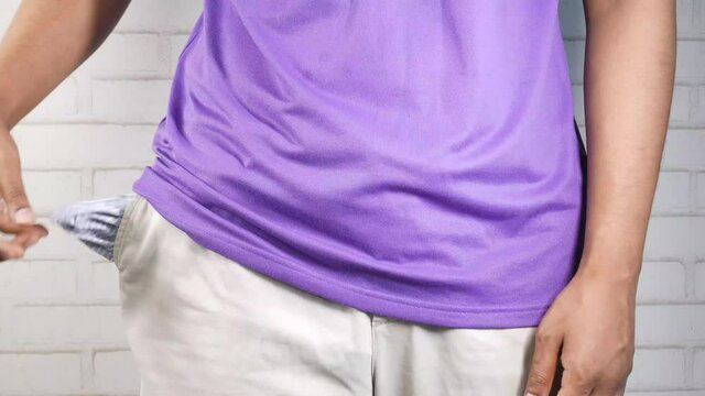 young man shows empty pant pocket with copy space 
