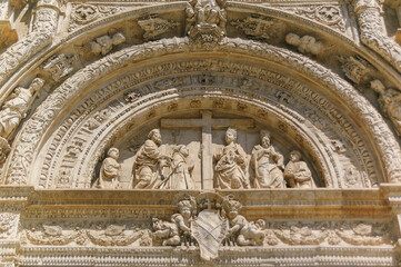 Old church entrance decoration with figures | Malaga, Spain