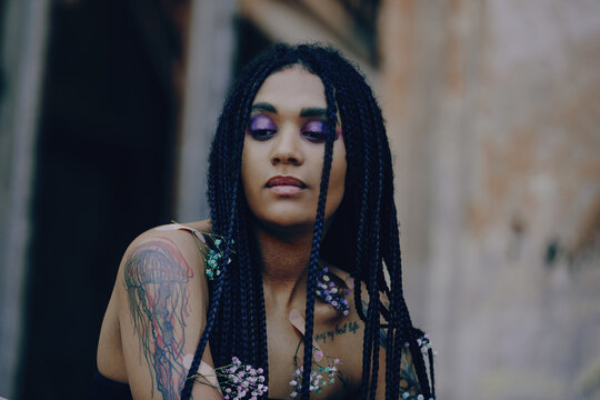 Portrait of a young beautiful tattooed girl with box braids hairstyle