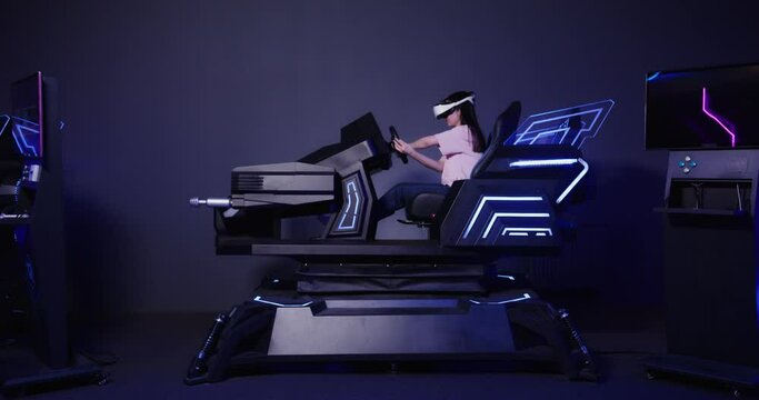 Asian girl in virtual reality glasses drives a car in 5D