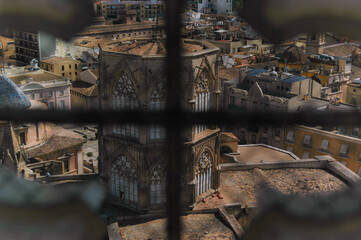 Fototapeta na wymiar Old spainish church tower view through fence